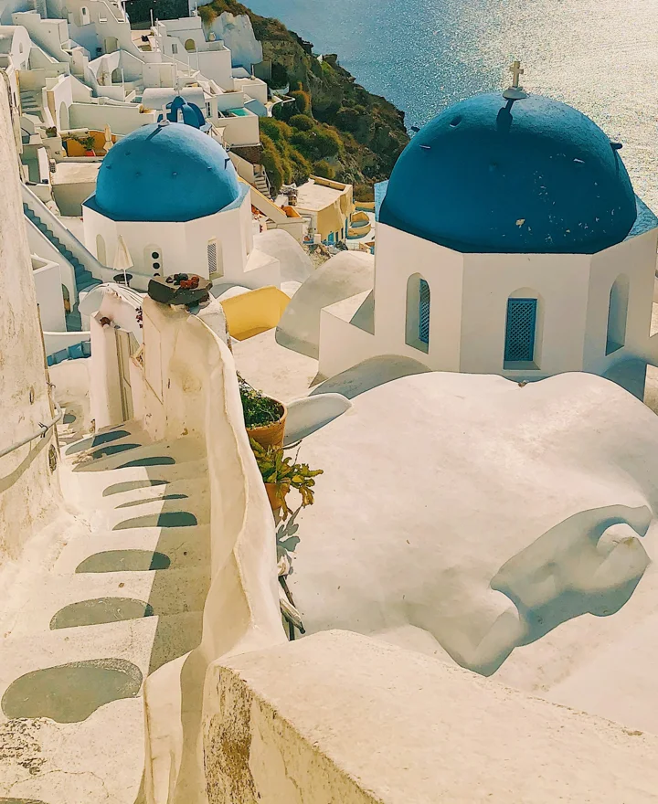 Blue-domed church and winding whitewashed steps in Santorini